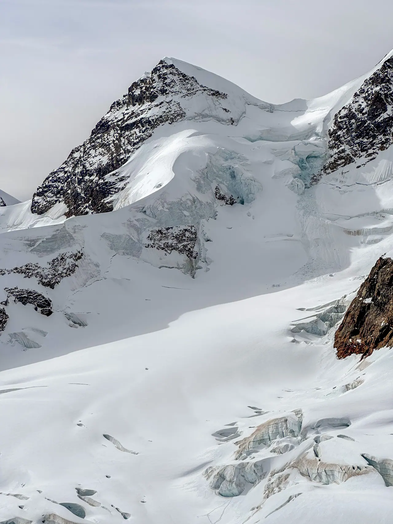 Glacial ice gathered between dark rock faces