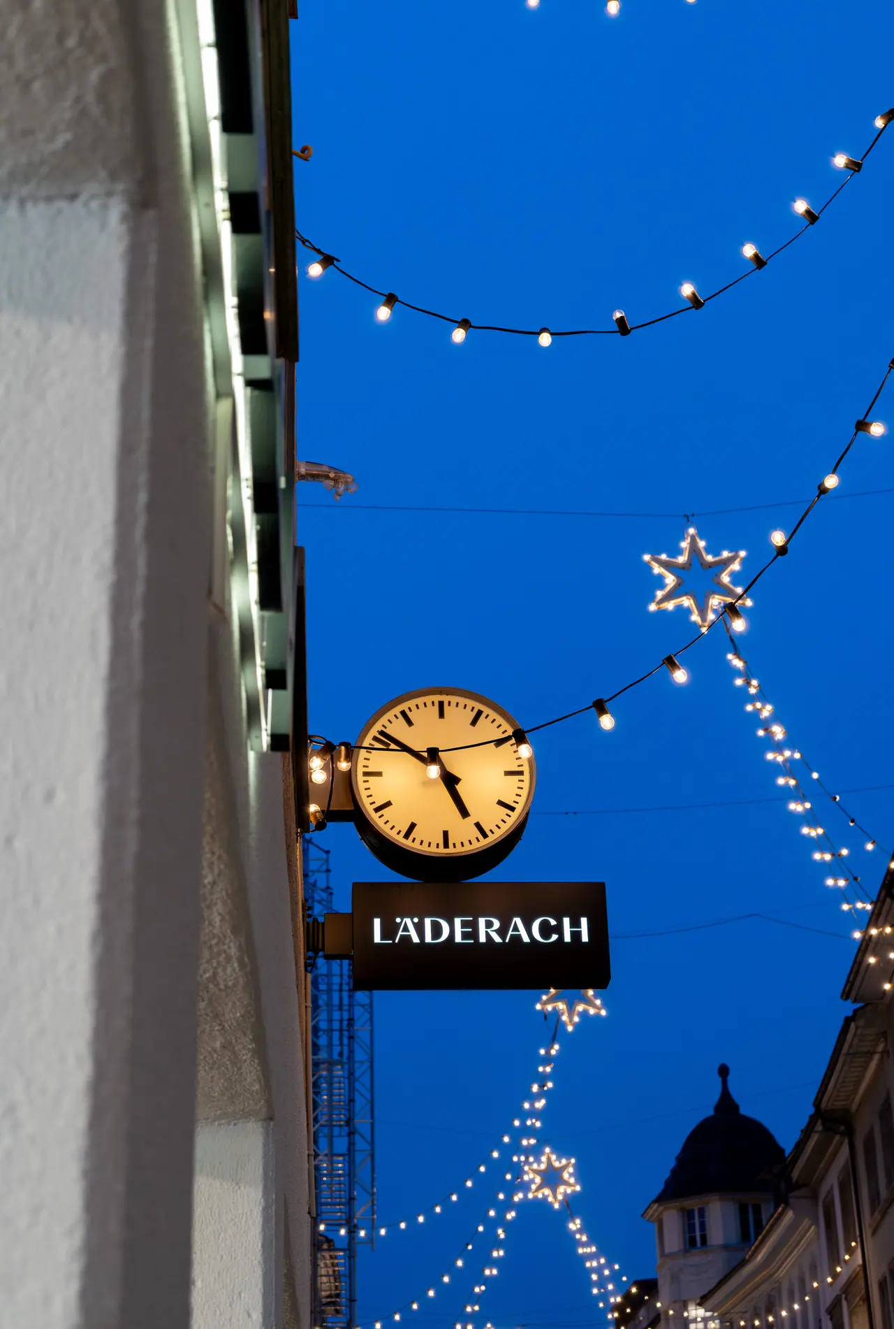 A confectioner clock beneath a deep blue sky